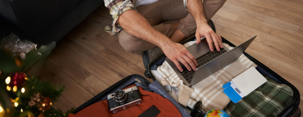 Holiday website maintenance checklist beside a laptop and seasonal calendar